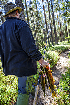 At the Rupkivi characteristic rock in the Savinajoki river, anglers on the Bear Circle hiking trail, Finland