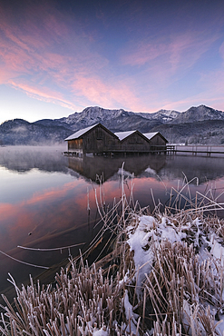 Wooden huts and footbridge on the Kochelsee at sunrise, in the foreground the icy lake shore, Schlehdorf, Bavaria, Germany, Europe