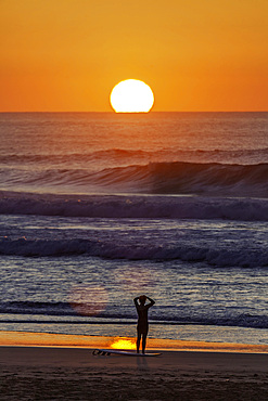 Europe, Portugal, Algarve, sunset, Atlantic, surfer looking at the sea