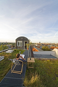 Man in a deck chair on a roof, Kreuzberg, Berlin, Germany