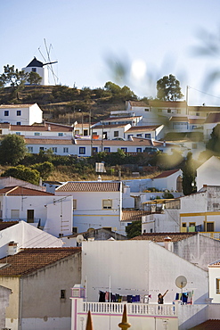 View of the village, windmill and white painted houses on a hill, Odeceixe, Algarve, Portugal