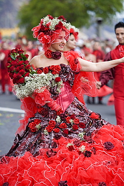 Woman with dress full of roses at the Madeira Flower Festival Parade, Funchal, Madeira, Portugal