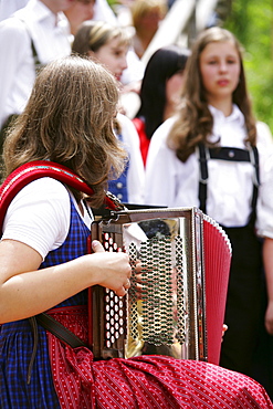 Woman playing harmonica, Styria, Austria