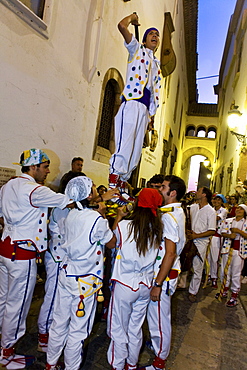 People in costumes in an alley in the evening, Festival of Santa Tecla, Sitges, Catalonia, Spain, Europe