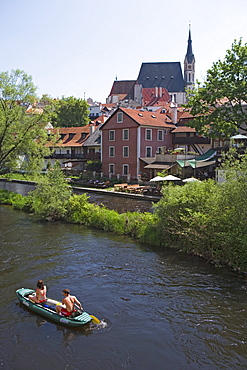 Canoeing on the Vltava river with the old town and the church of St. Veit in the back, Cesky Krumlov, South Bohemian Region, Czech Republic