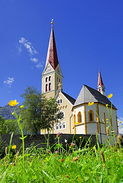 sea of flowers with church in Holzgau, valley Lechtal, Tyrol, Austria