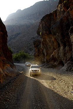 Two all-terrain vehicles on a road in the mountains, Al Hajar mountains, Wadi Bani Auf, Oman, Asia