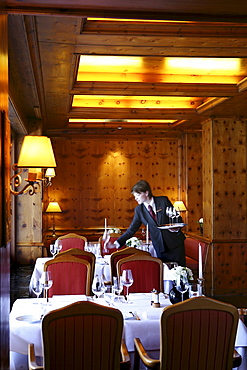 A waitress laying a table at Restaurant Zirbelstube, Hotel at Schlossgarten, Stuttgart, Baden-Wurttemberg, Germany