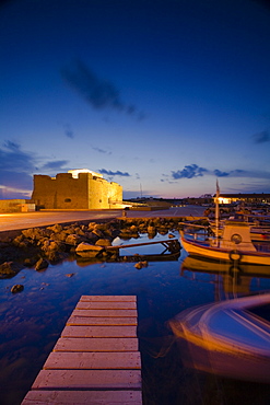 Paphos Castle at night with fishing boats, Paphos harbour, Paphos, South Cyprus, Cyprus