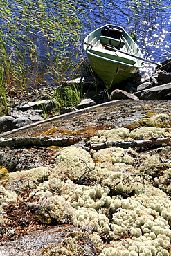 Rowing boat at the shore of an uninhabited island, Saimaa Lake District, Finland, Europe