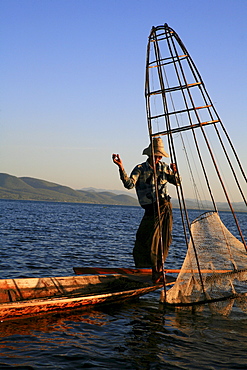 Intha fisherman with fish trap in the evening light, Inle Lake, Shan State, Myanmar, Burma, Asia