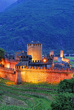 Illuminated castle Castello di Montebello and castle Castelgrande in background in UNESCO World Heritage Site Bellinzona, Bellinzona, Ticino, Switzerland