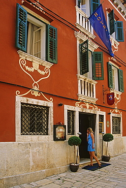 A woman in front of a hotel at Pula, Croatian Adriatic Sea, Istria, Croatia, Europe