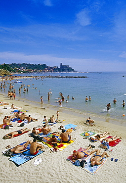 People sunbathing on the beach under blue sky, Golfo della Spezia, Italian Riviera, Liguria, Italy, Europe