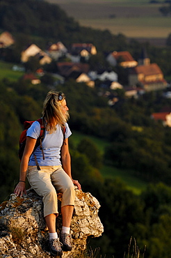 Woman on a mountain looking at the view, Walberla, Bavaria, Germany, Europe