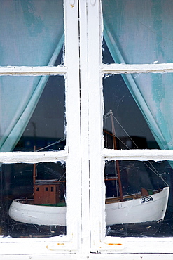 Ship model of a fishing boat standing in a window, Kaseberga, Ystad, Skane, South Sweden, Sweden