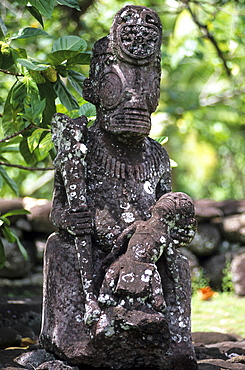 Weather beaten statue made of stone, Tiki in the village of Hatiheu on the island of Nuku Hiva, French Polynesia