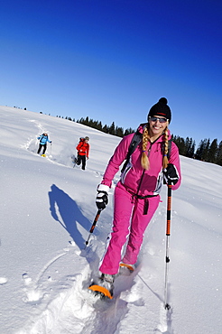 Young woman snowshoeing, Hemmersuppenalm, Reit im Winkl, Chiemgau, Upper Bavaria, Bavaria, Germany, Europe