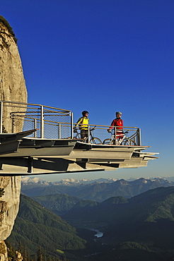 People on mountain bikes on viewing platform at Triassic Park, Reit im Winkl, Bavaria, Germany, Europe