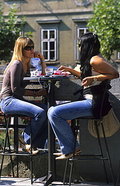 Two young women sitting in a cfafe in the historic centre of Ljubljana, Slovenia