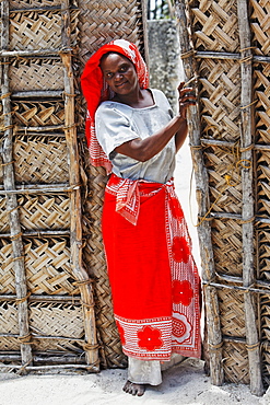 Woman at the entrace to her kraal, Jambiani, Zanzibar, Tanzania, Africa