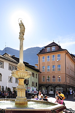 Group of persons in front of fountain of Kaltern, Kaltern, South Tyrol, Italy, Europe