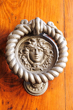 Door knocker in the shape of a face, Montepulciano, Tuscany, Italy