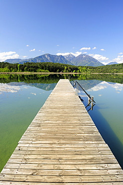 Wooden landing stage leading into lake Turnersee, Karawanken range in the background, lake Turnersee, Carinthia, Austria, Europe