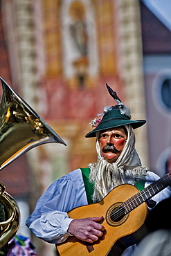 Disguised person playing the guitar at carnival, Mittenwald, Bavaria, Germany, Europe