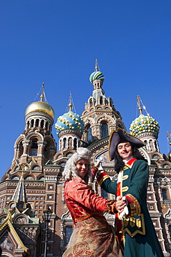 Couple in historic costumes pose as Empress and Tsar in front of Church of the Savior on Spilled Blood, Church of the Resurrection, St. Petersburg, Russia