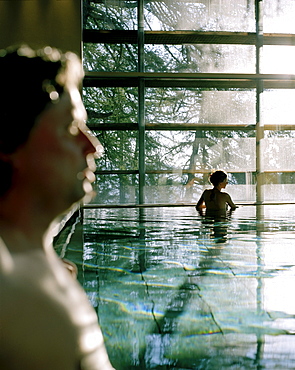 Couple bathing in indoor pool, Vigilius Mountain Resort, Vigiljoch, Lana, Trentino-Alto Adige/Suedtirol, Italy