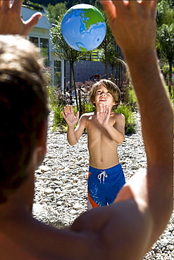 A man and a boy playing ball, South Tyrol, Italy, Europe