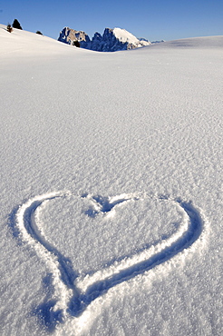 Heart in the snow in the sunlight, Alpe di Siusi, Puflatsch, Alto Adige, South Tyrol, Italy, Europe