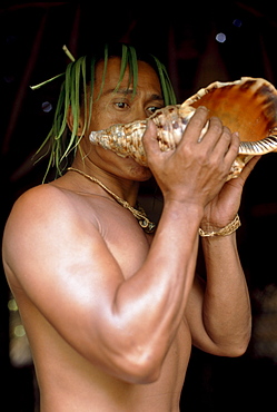 Native blowing in a shell, Tiki Theatre Village, Moorea, Polynesia