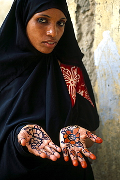 Portrait of a muslim woman with painted hands, Zanzibar, Tanzania, Africa