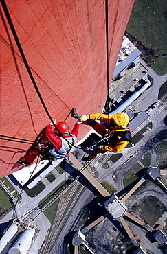 Two workers secured with ropes working on vertical surface, chimney, renovation works, Duernrohr power plant, Zwentendorf an der Donau, Lower Austria