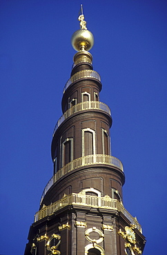 Steeple of Vor Frelser church under blue sky, Copenhagen, Denmark, Europe