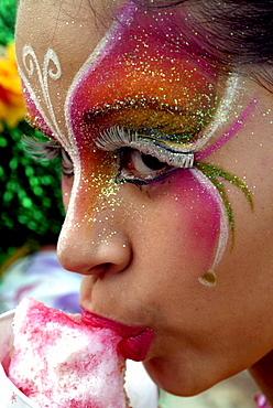 Painted girl eating ice cream, Baranquilla, Colombia, South America