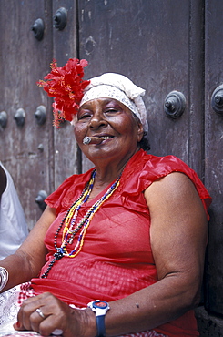 Mature woman smoking a cigar at the old town, Plaza de la Catedral, La Habana Vieja, Cuba, Caribbean, America