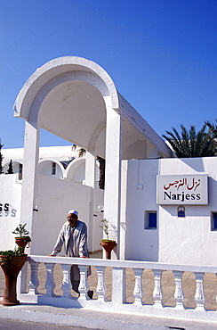 Person in front of the Dar Djerba hotel, Djerba, Tunesia, Africa