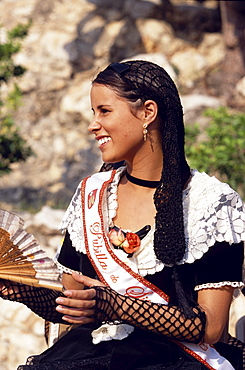 Young women in traditional dress representing different villages at the Wine Festival in Sitges, Costa de Garraf, Spain