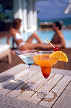 A couple sat behind a refreshing cocktail at the pool of Casa Colonial Beach and Spa, the Playa Dorada, Puerto Plata, Dominican Republic, Caribbean