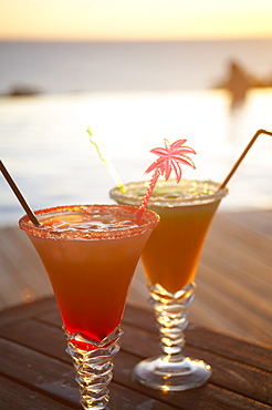 Colourful cocktails at the pool of Hotel Restaurant Le Rayon Vert in the evening, Deshaies, Basse-Terre, Guadeloupe, Caribbean Sea, America