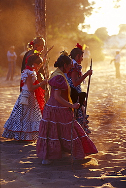 Pilgrims walking with hiking stick along a sandy road, Andalusia, Spain