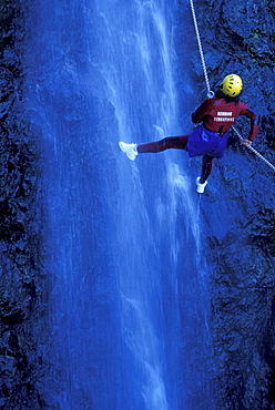 Person canyoning at Gobert Waterfall, Cilaos, La RÃˆunion, Indian Ocean