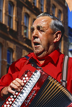 Old musician with accordion, St. Peter Port, Guernsey, Channel Islands, UK