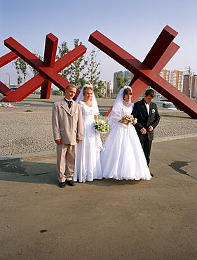 Newlyweds posing in front of the war memorial, Khimki, Moscow, Russia