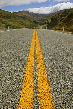 Yellow double medial strip on a country road in Otago, South Island, New Zealand, Oceania