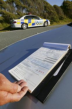 Policeman drawing a speeding ticket, Highway 6, West Coast, South Island, New Zealand, Oceania