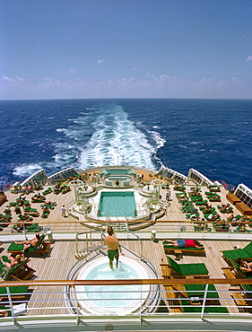 People sunbathing on quarterdeck of the cruise ship Queen Mary 2